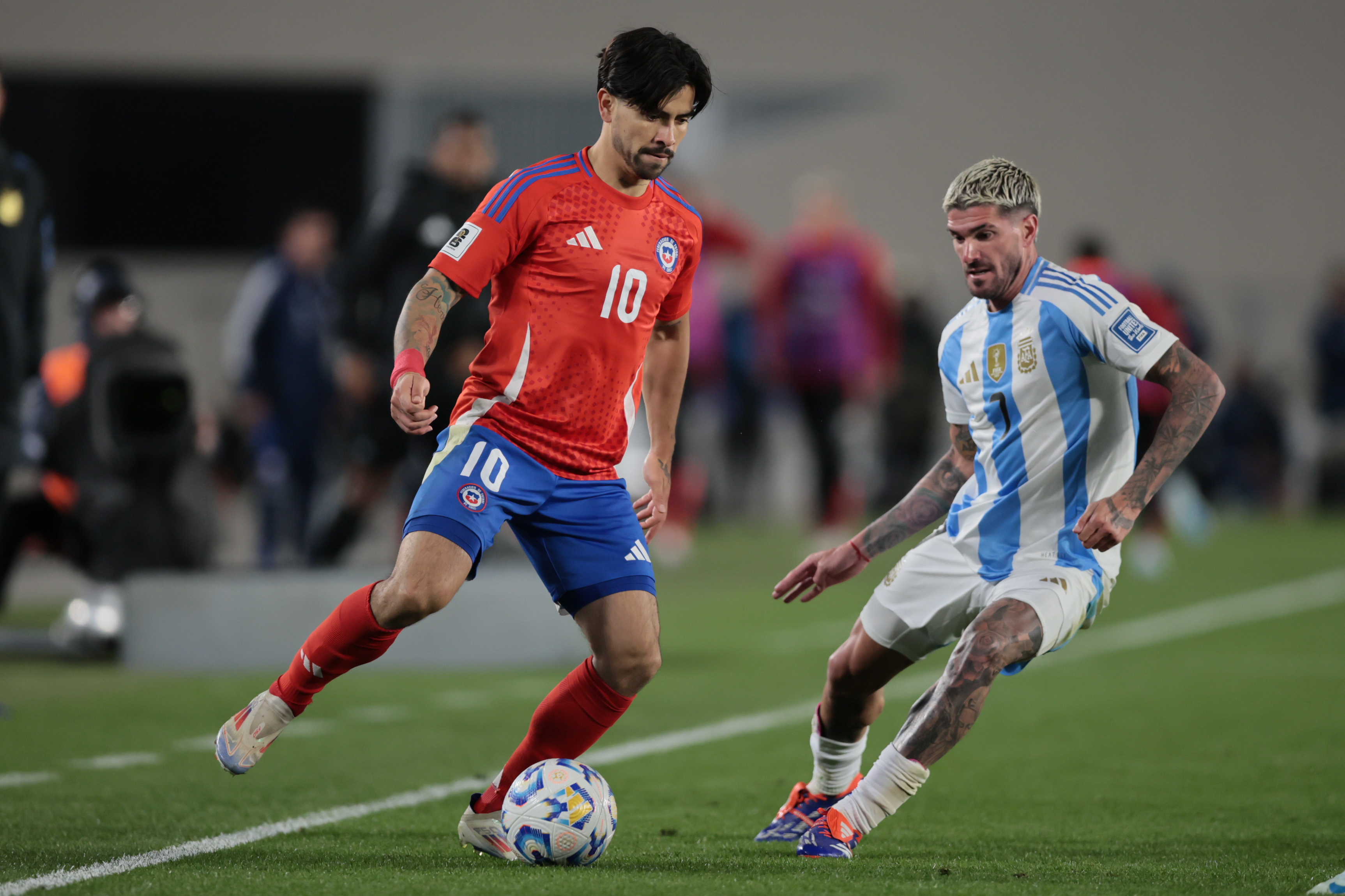 "Argentina vs Chile" 2024 Buenos Aires, Argentina - September 5, 2024. Victor Davila (left) eludes Rodrigo De Paul (right) ...