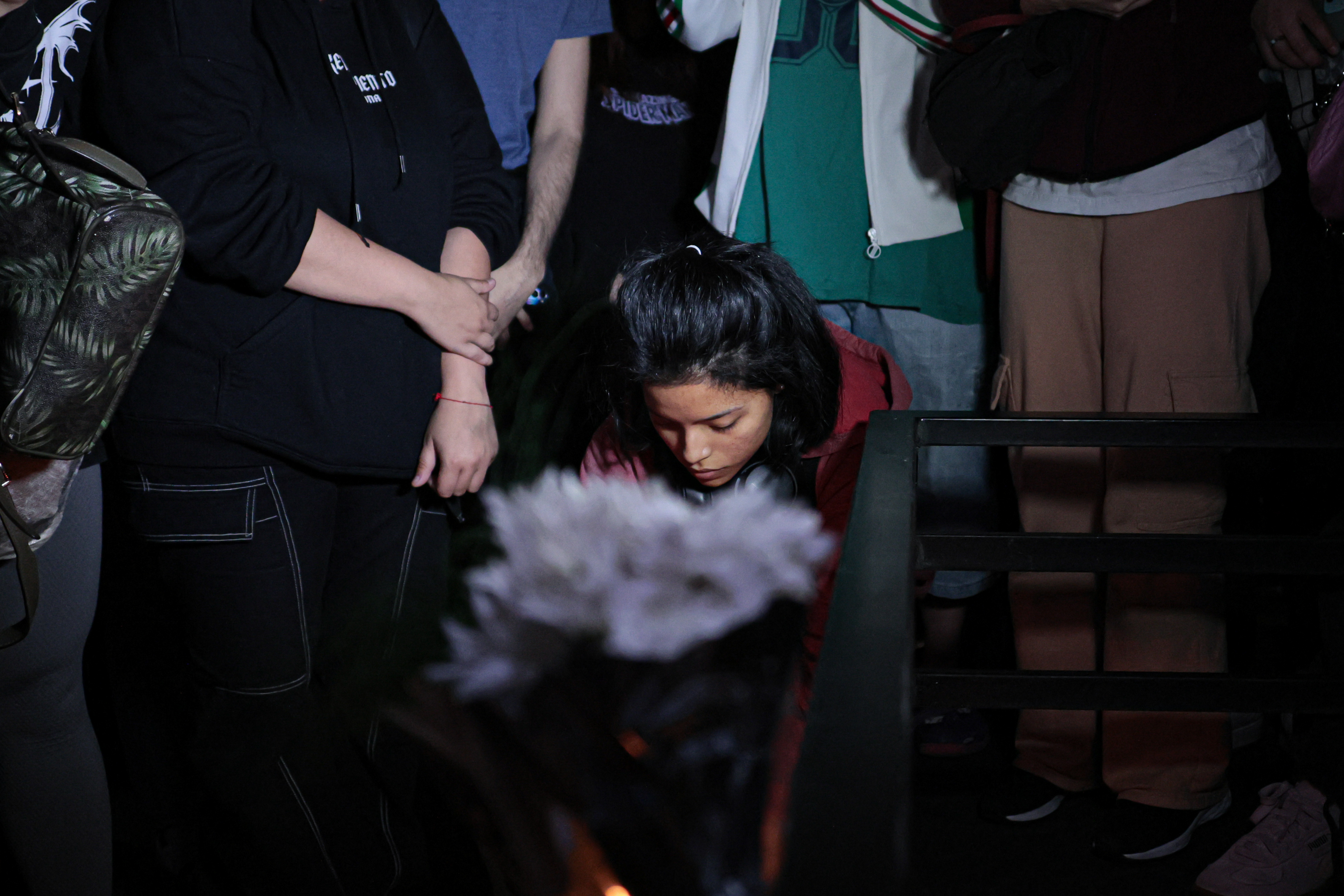 fans cry and light candles for Liam Payne, British singer and former member of the popular boy ba...