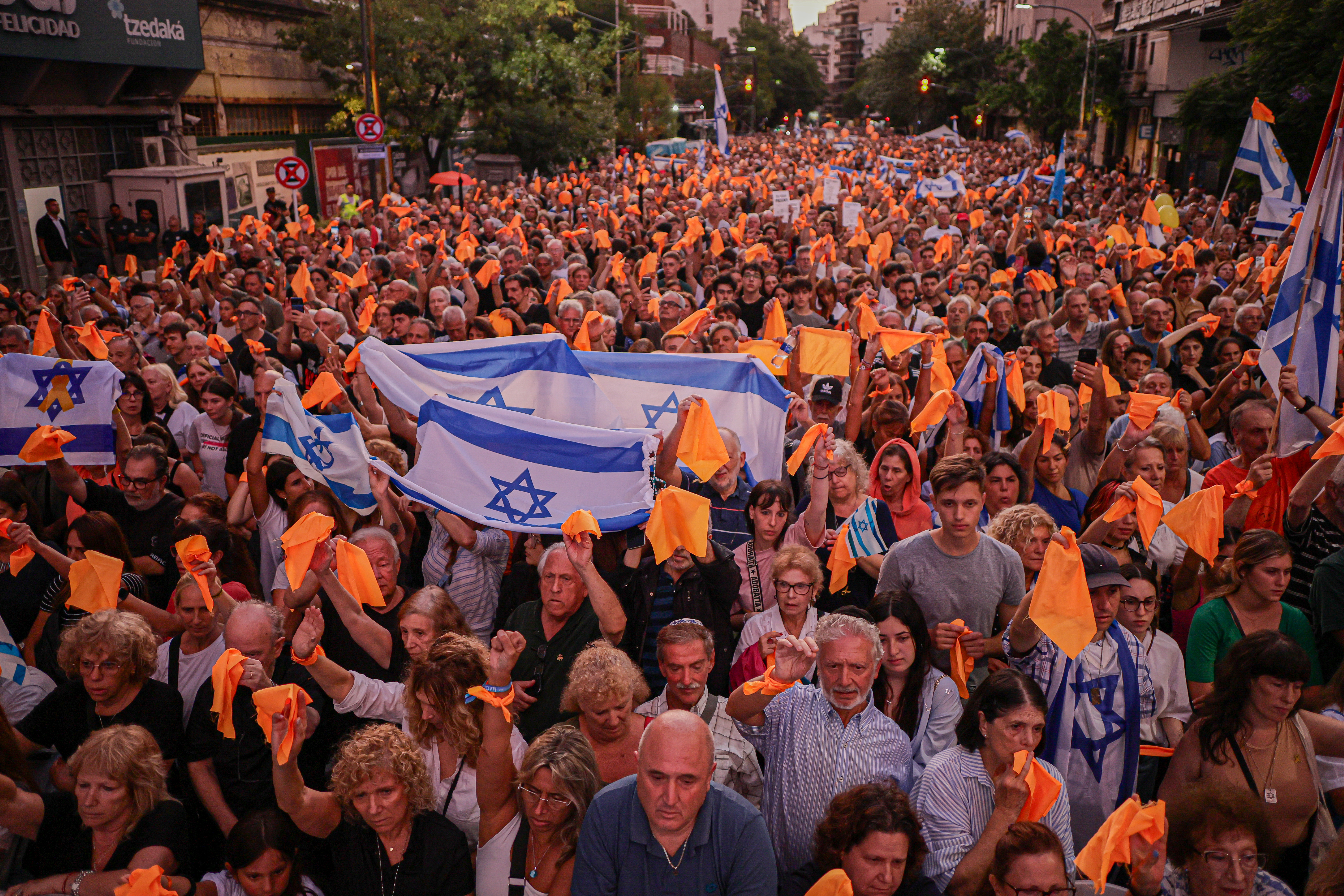 Demonstrators Wave Israeli Flags in Argentina, Calling for Freedom of Captives Buenos Aires, Argentina – February 24, 2025: People hold Israeli flags during a demonstration i...