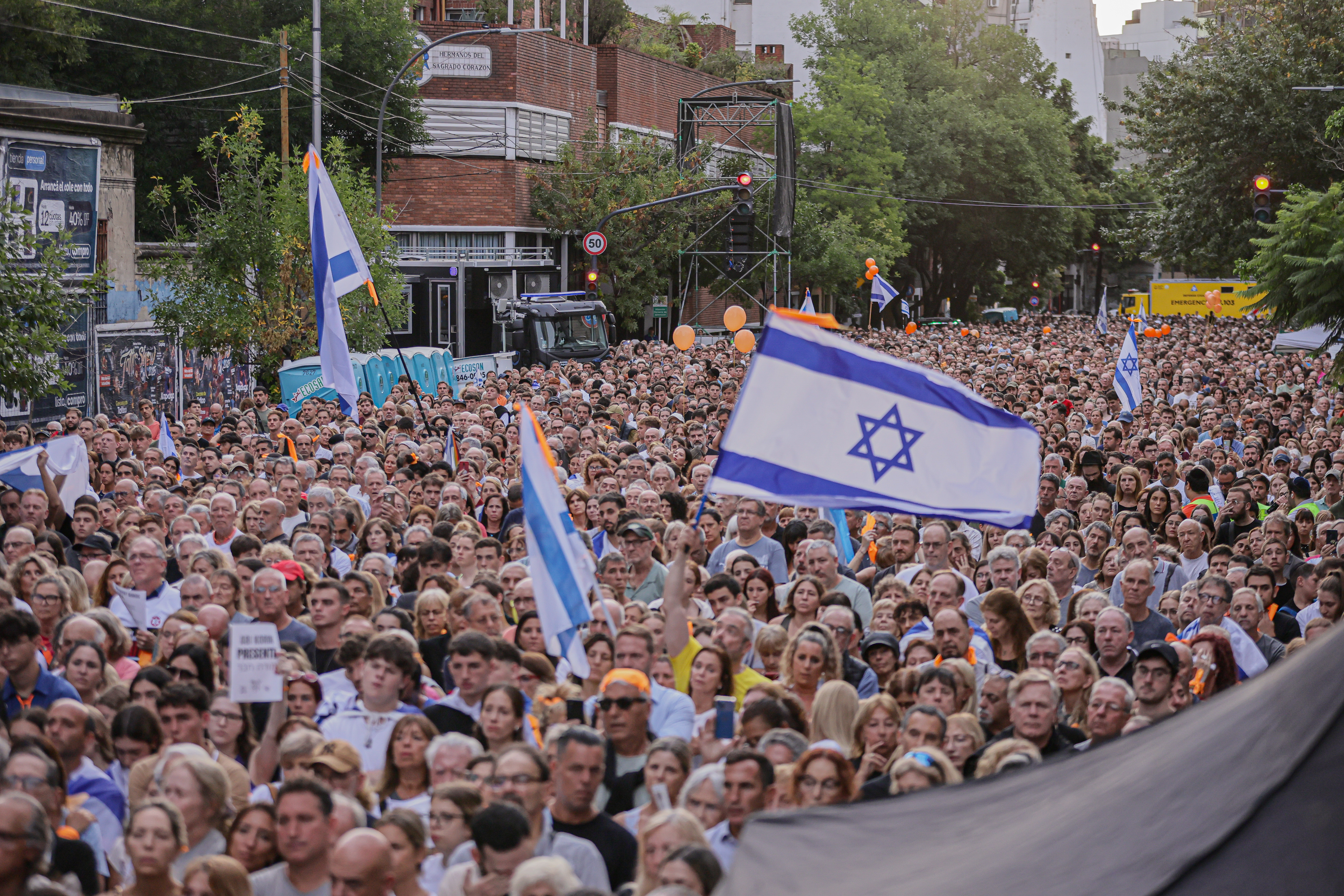 Demonstrators Wave Israeli Flags in Argentina, Calling for Freedom of Captives Buenos Aires, Argentina – February 24, 2025: People hold Israeli flags during a demonstration i...