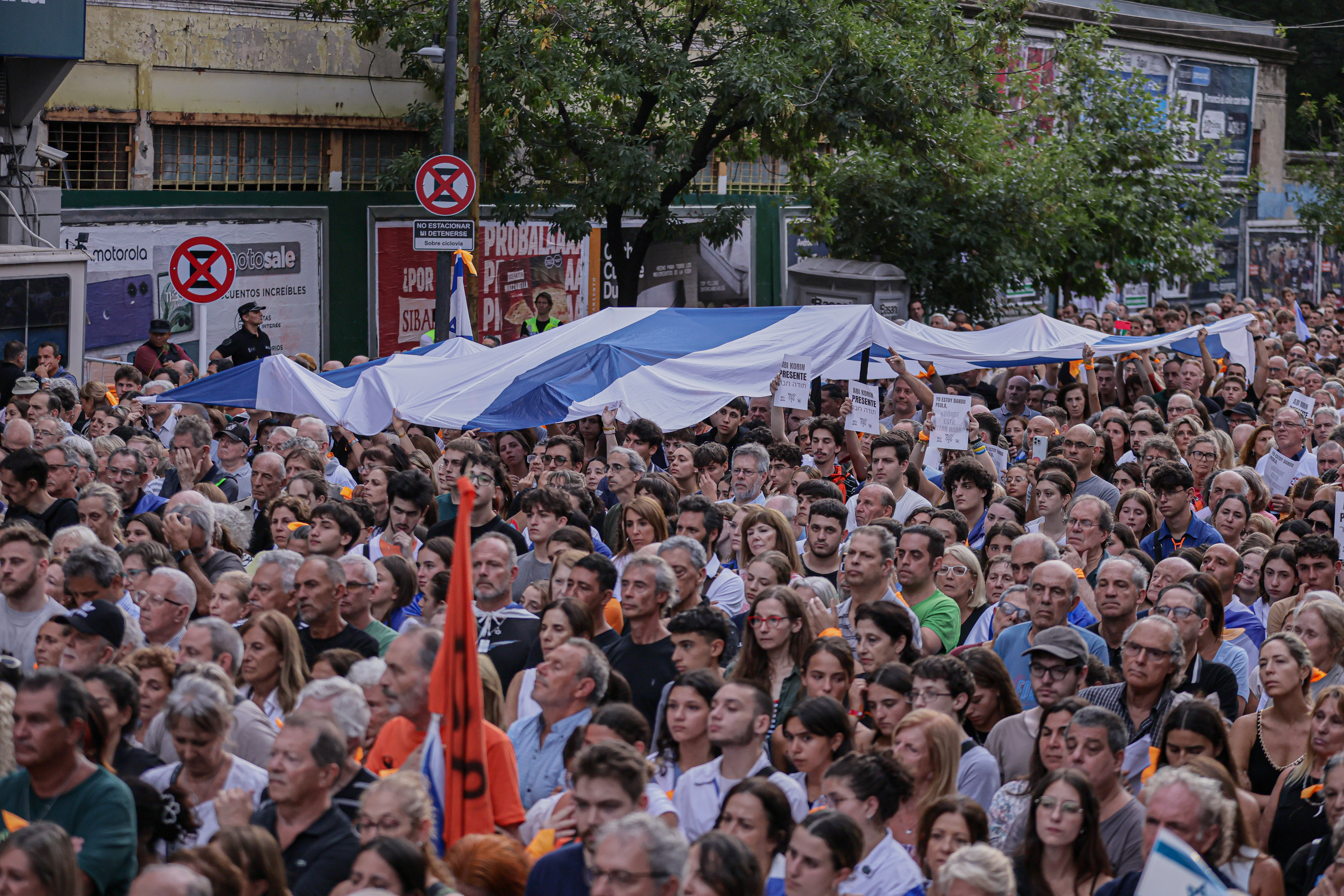 Buenos Aires, Argentina – February 24, 2025: People hold Israeli flags during a demonstration i...