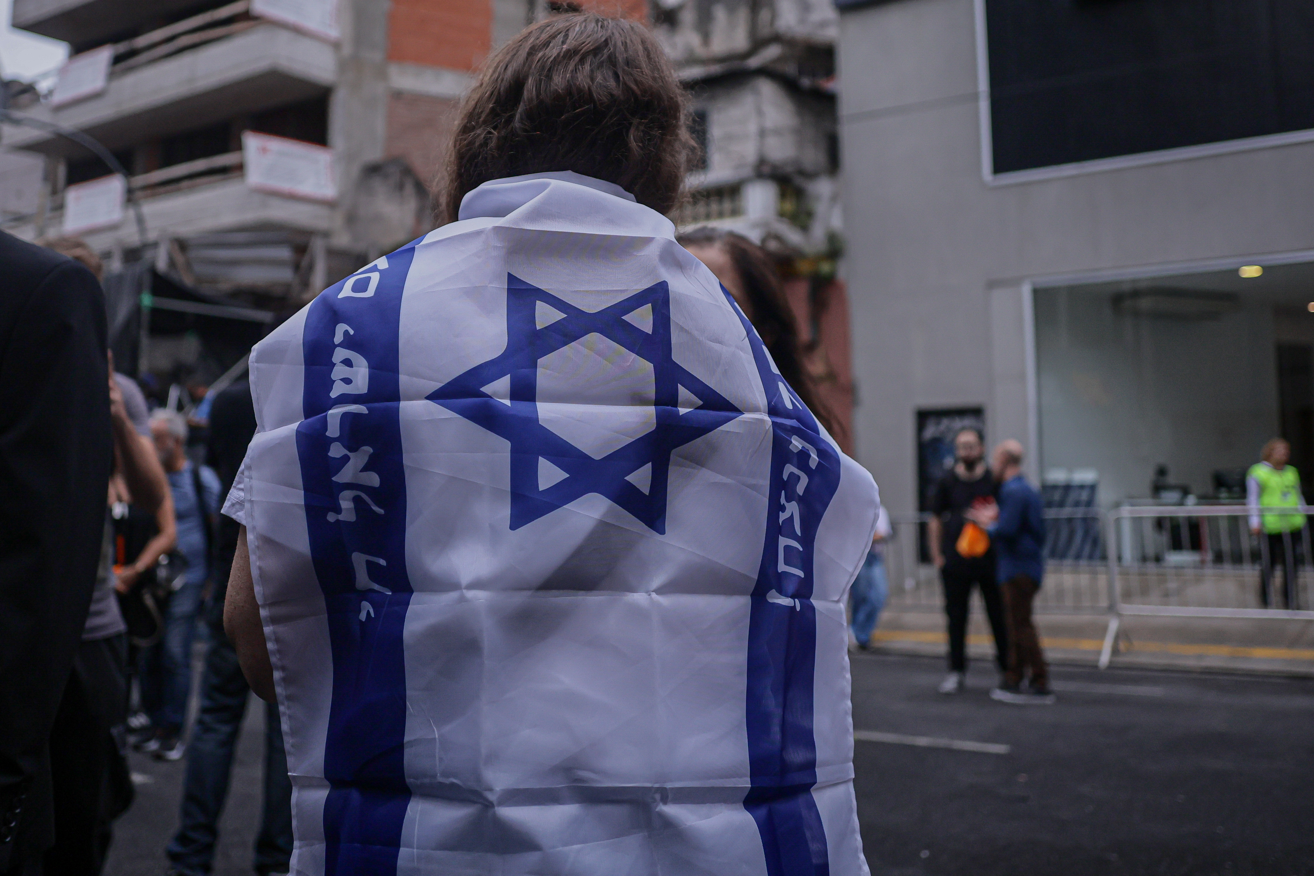 Buenos Aires, Argentina – February 24, 2025: People hold Israeli flags during a demonstration i...