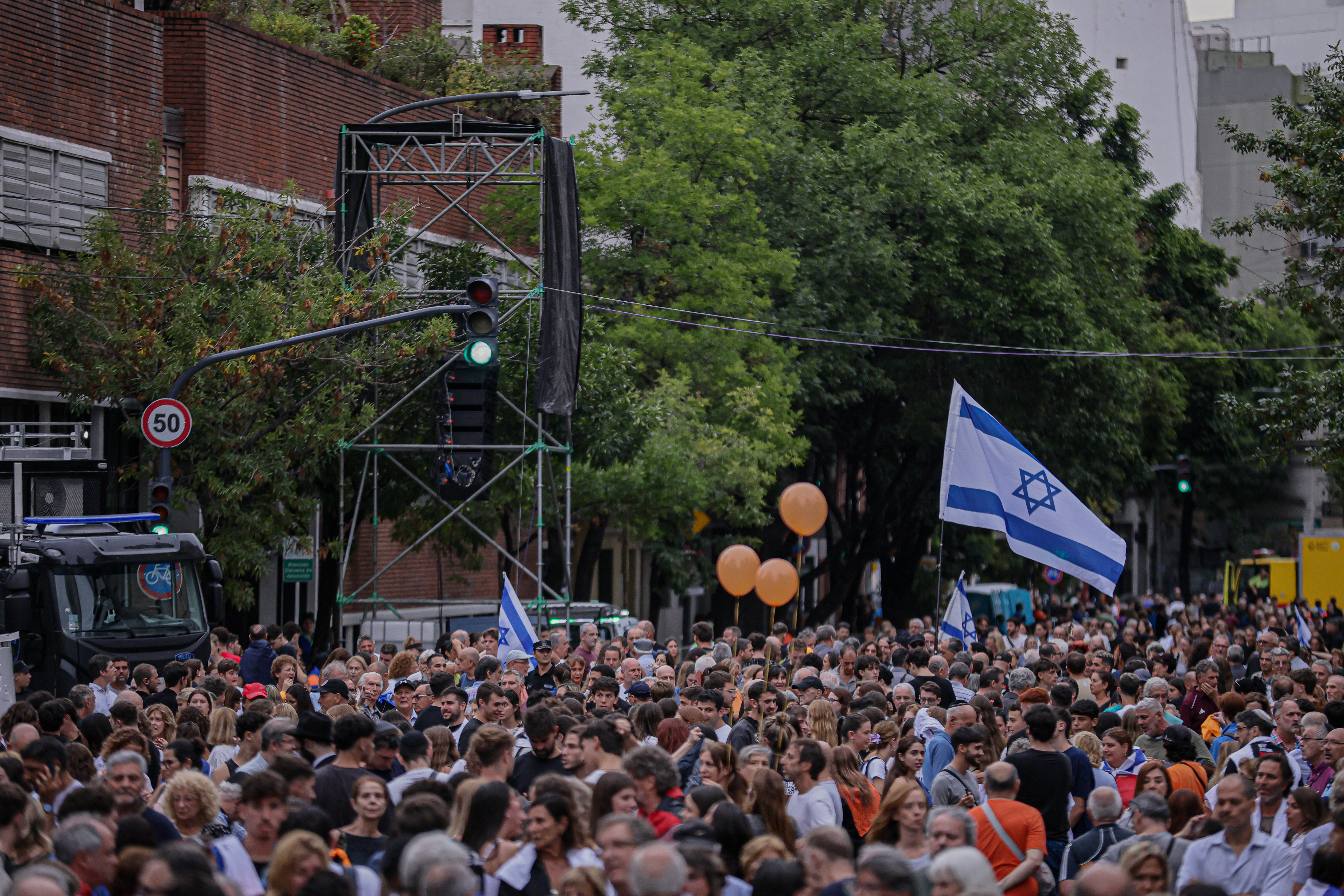 Buenos Aires, Argentina – February 24, 2025: People hold Israeli flags during a demonstration i...