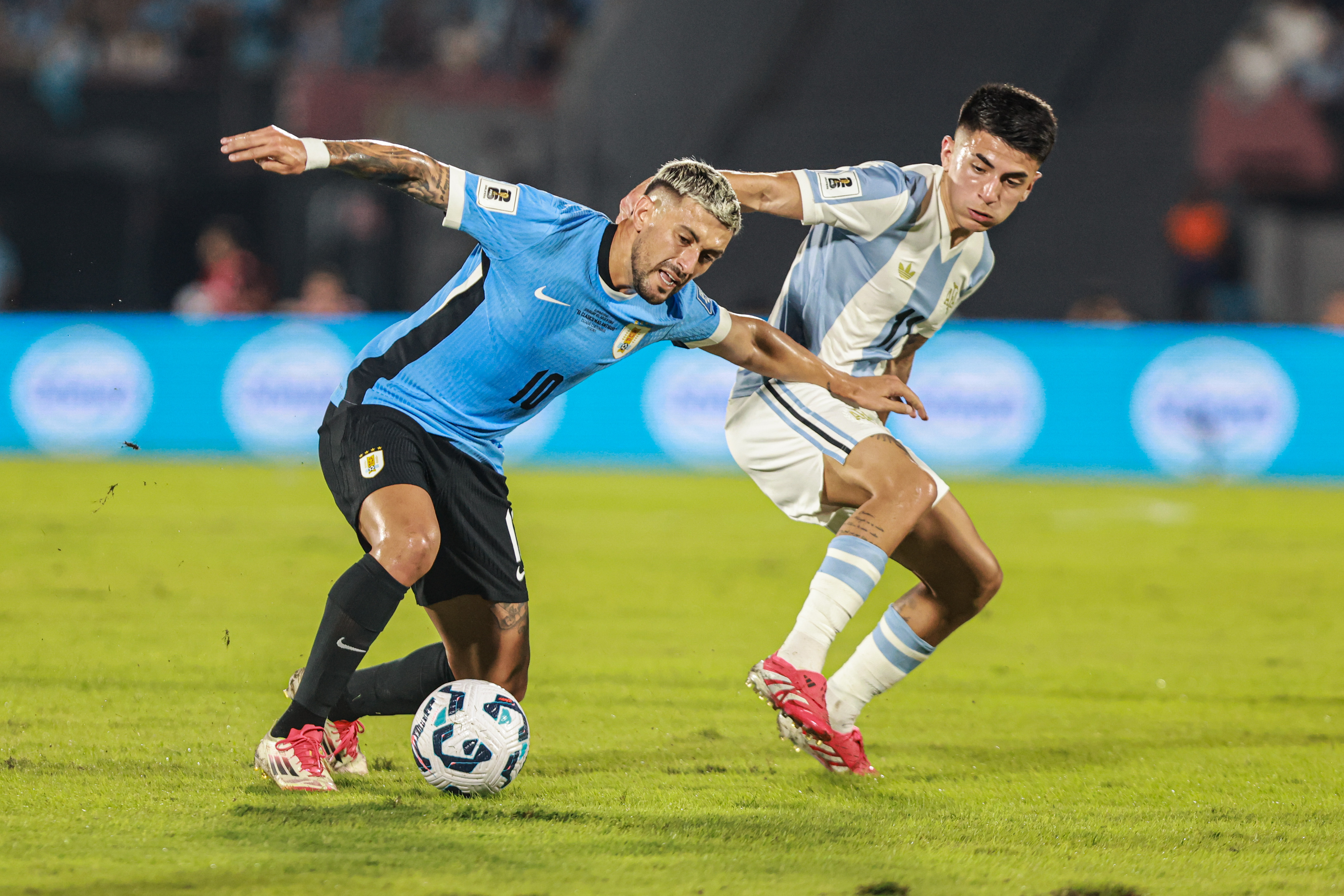 South American Rivals Face Off at Estadio Centenario for Matchday 13 Montevideo, Uruguay – March 21, 2025: Giorgian de Arrascaeta (L) from Uruguay faces Thiago Al...