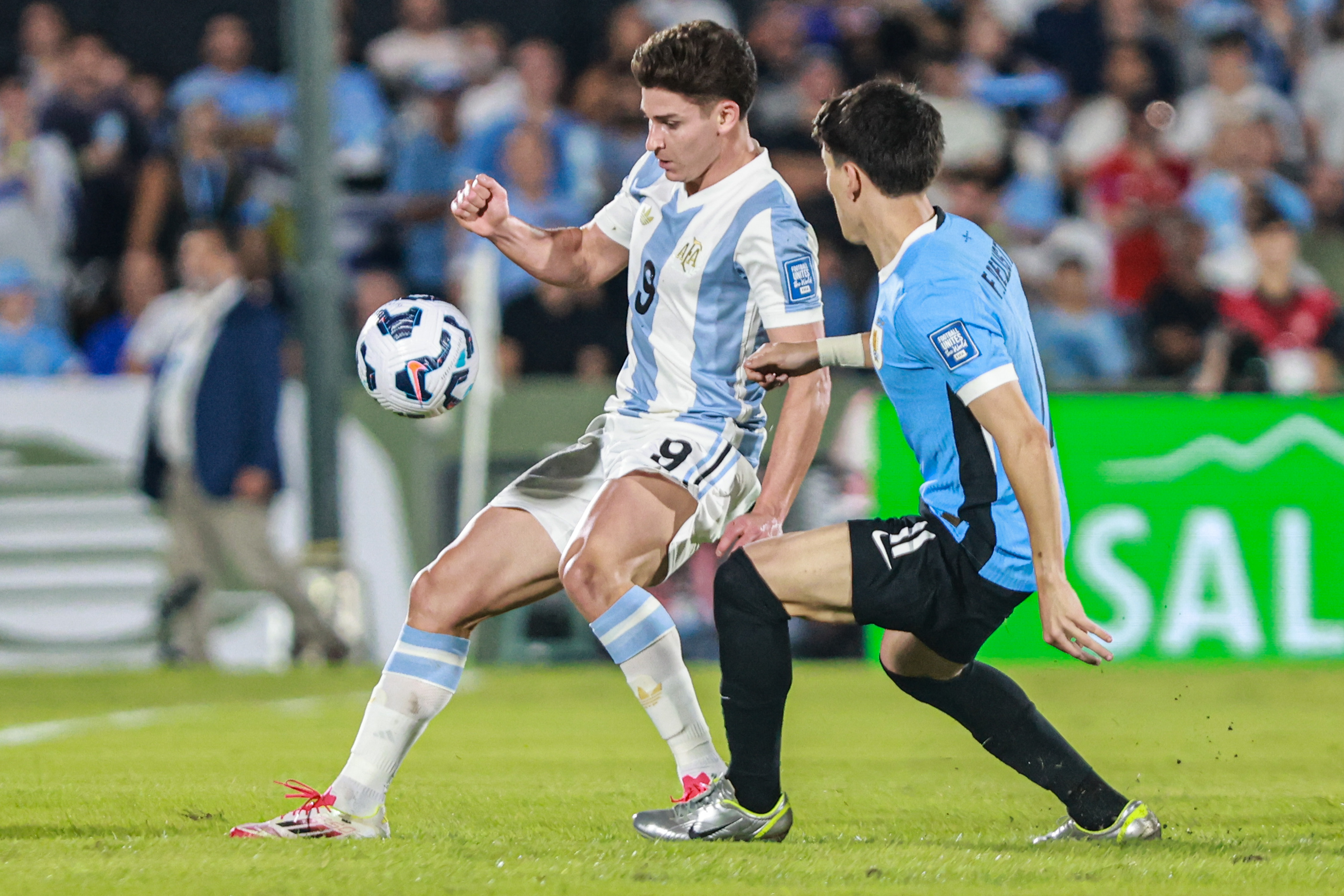 South American Rivals Face Off at Estadio Centenario for Matchday 13 Montevideo, Uruguay – March 21, 2025: Julian Alvarez (L) from Argentina control a ball agains...