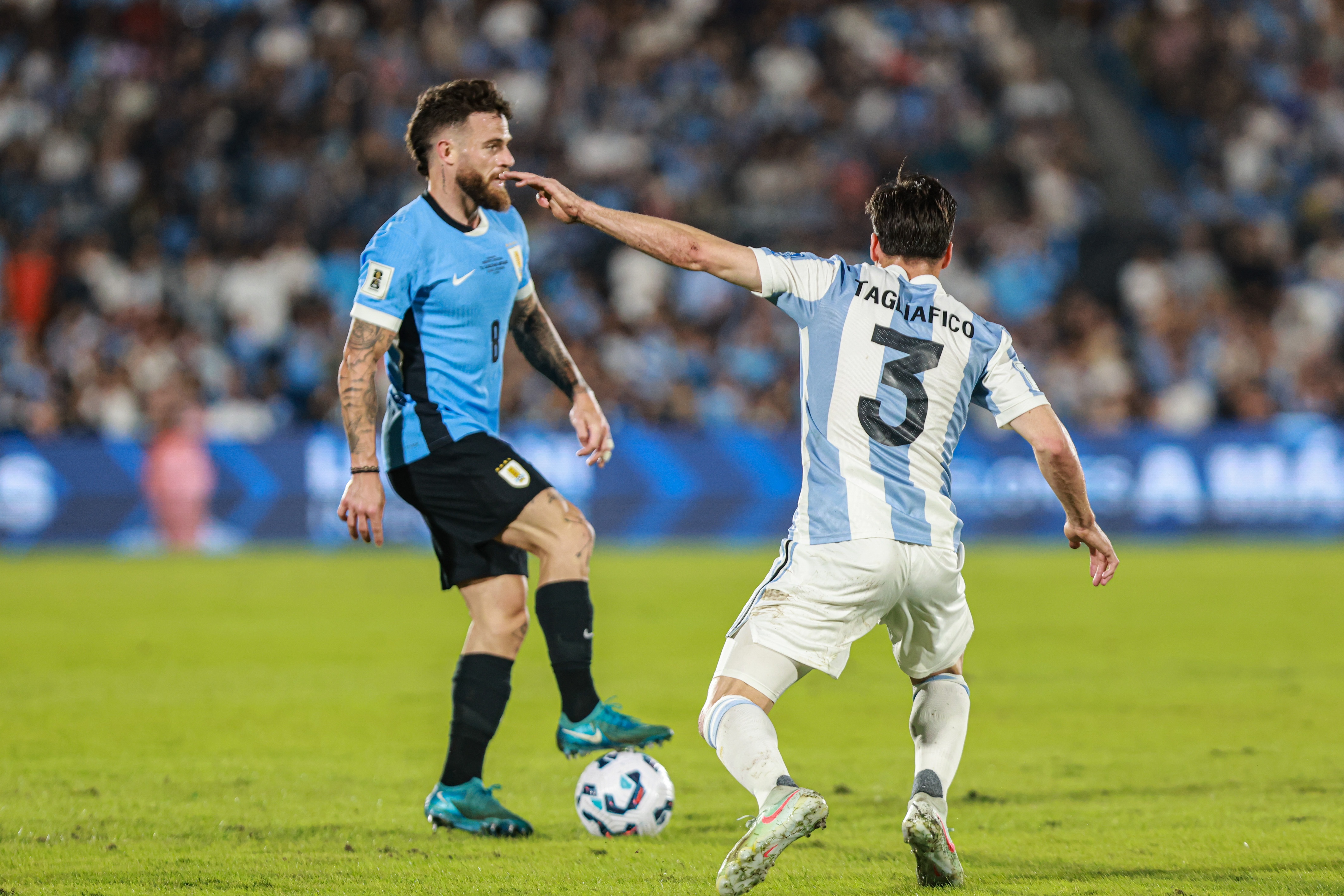 South American Rivals Face Off at Estadio Centenario for Matchday 13 Montevideo, Uruguay – March 21, 2025: Nahitan Nandez (rear) from Uruguay control a ball against...