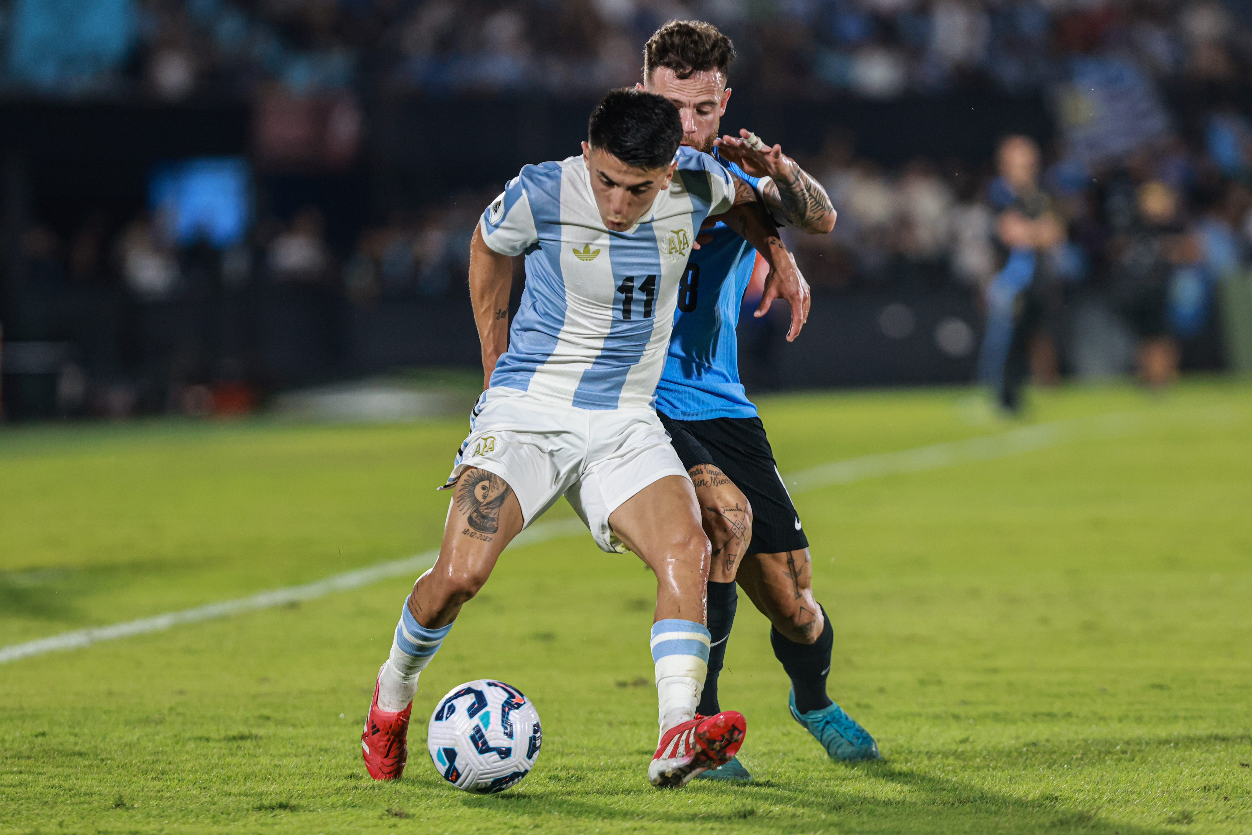 South American Rivals Face Off at Estadio Centenario for Matchday 13 Montevideo, Uruguay – March 21, 2025: Thiago Almada (L) from Argentina faces Nathan Nandez (R)...